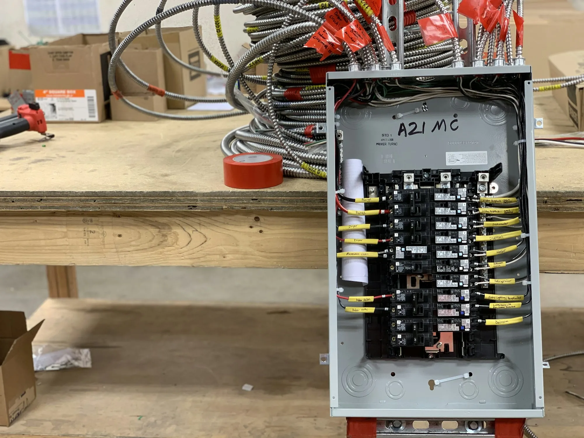 Electrical panel on a workbench with breakers and wiring