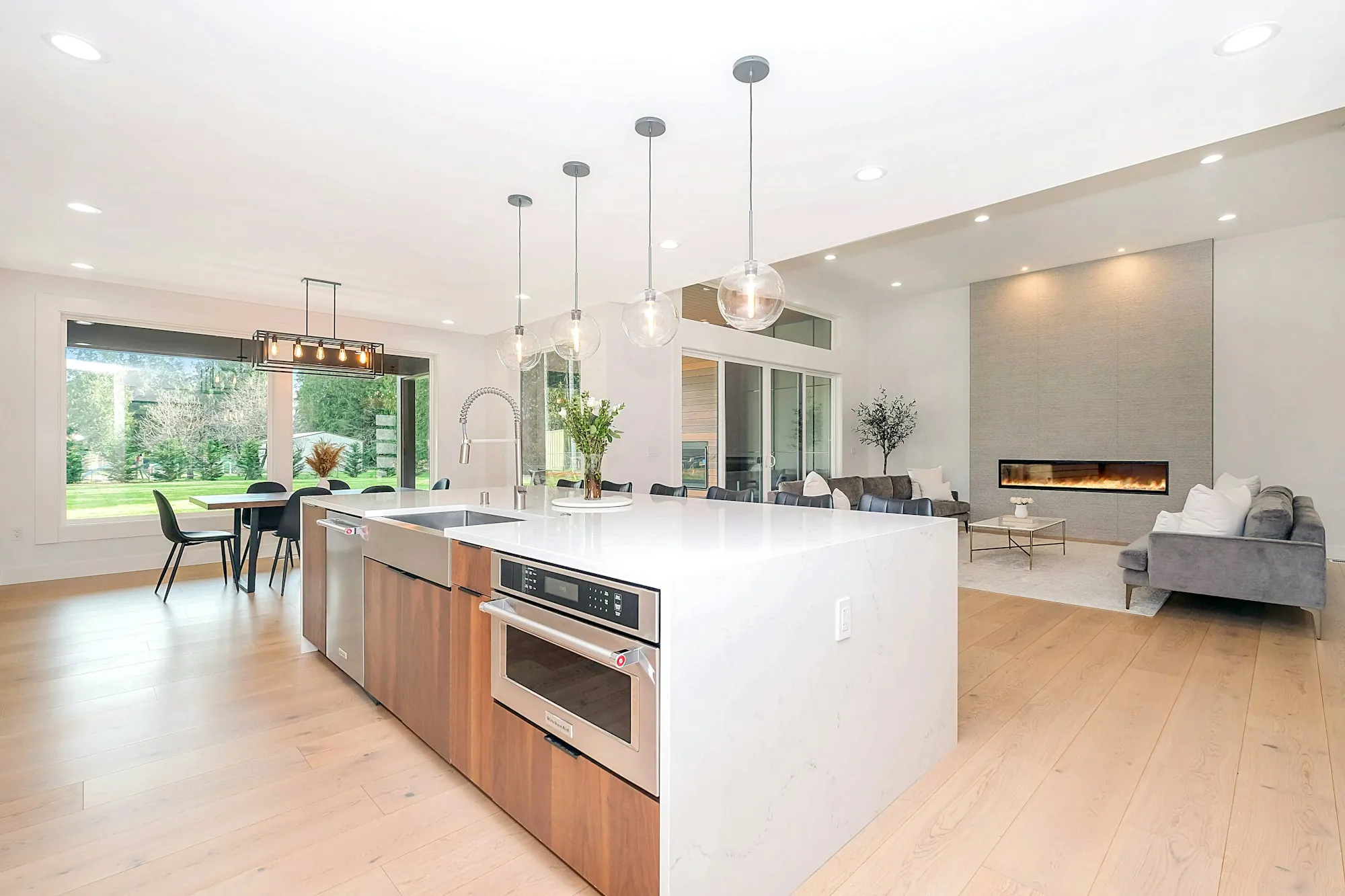 Bright modern kitchen and living area with new lighting